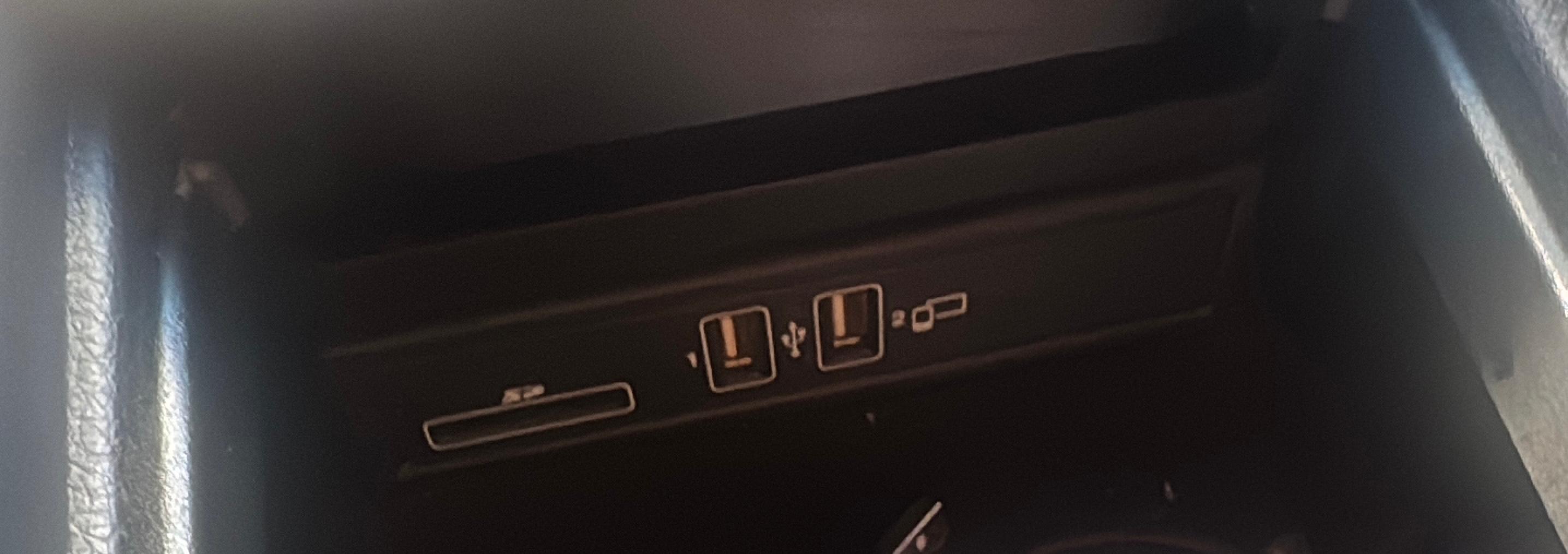 Mercedes centre-console USB ports with a phone symbol beside the smartphone-integration port